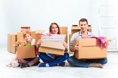 A moving team preparing boxes and equipment safely beside a van