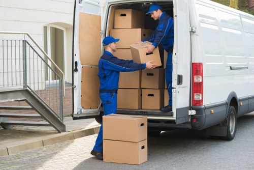 Packed moving boxes and furniture ready for collection during a Merton house move