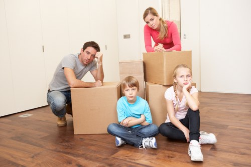 Organised flat removal process with boxes and furniture ready for transport