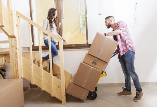 Packed boxes and furniture ready for loading into a removal van