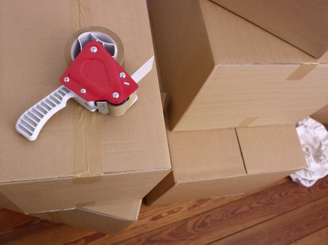 Mover wearing PPE while loading items into a moving van