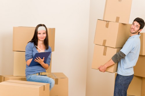 Professional movers handling furniture during a flat removal in Merton